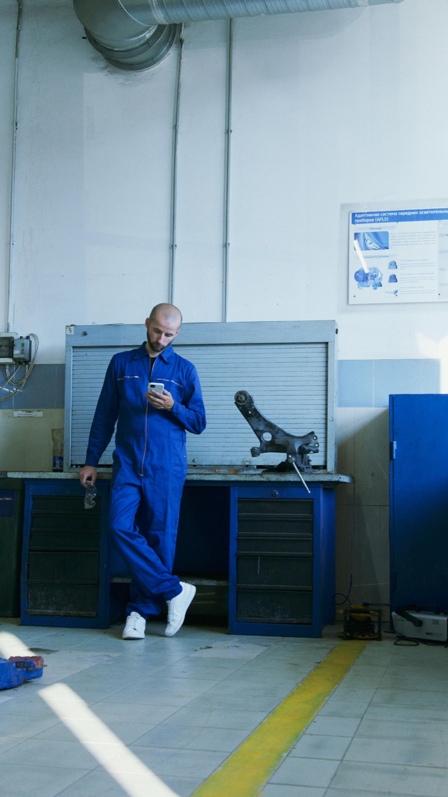 Tradesperson in coveralls on his phone